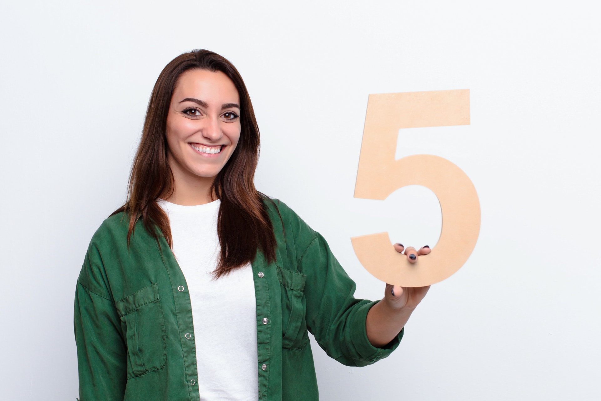 Donna sorridente mostra il numero 5, immagine sui cinque vantaggi dell’adesione automatica a Fondo Telemaco